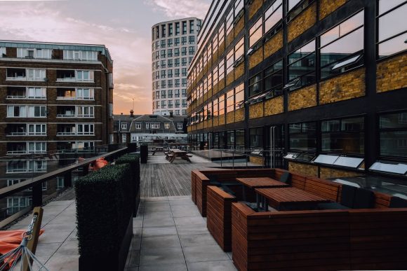 Housing estate with blocks of flats and concrete paving.